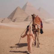 Girl holding camel in Giza Pyramids