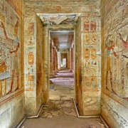 Colorful hieroglyph walls inside Temple of Seti I corridor with ancient Egyptian artwork